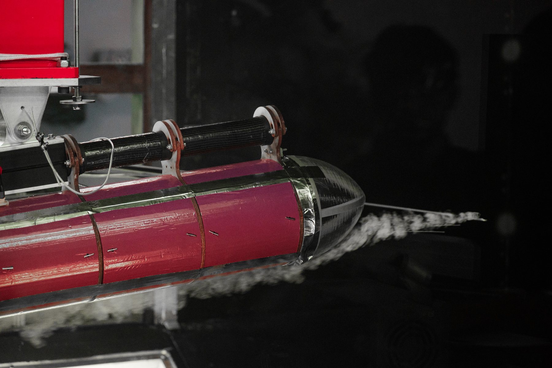 Smoke streaming over the fuselage and tail of the aircraft in the wind tunnel