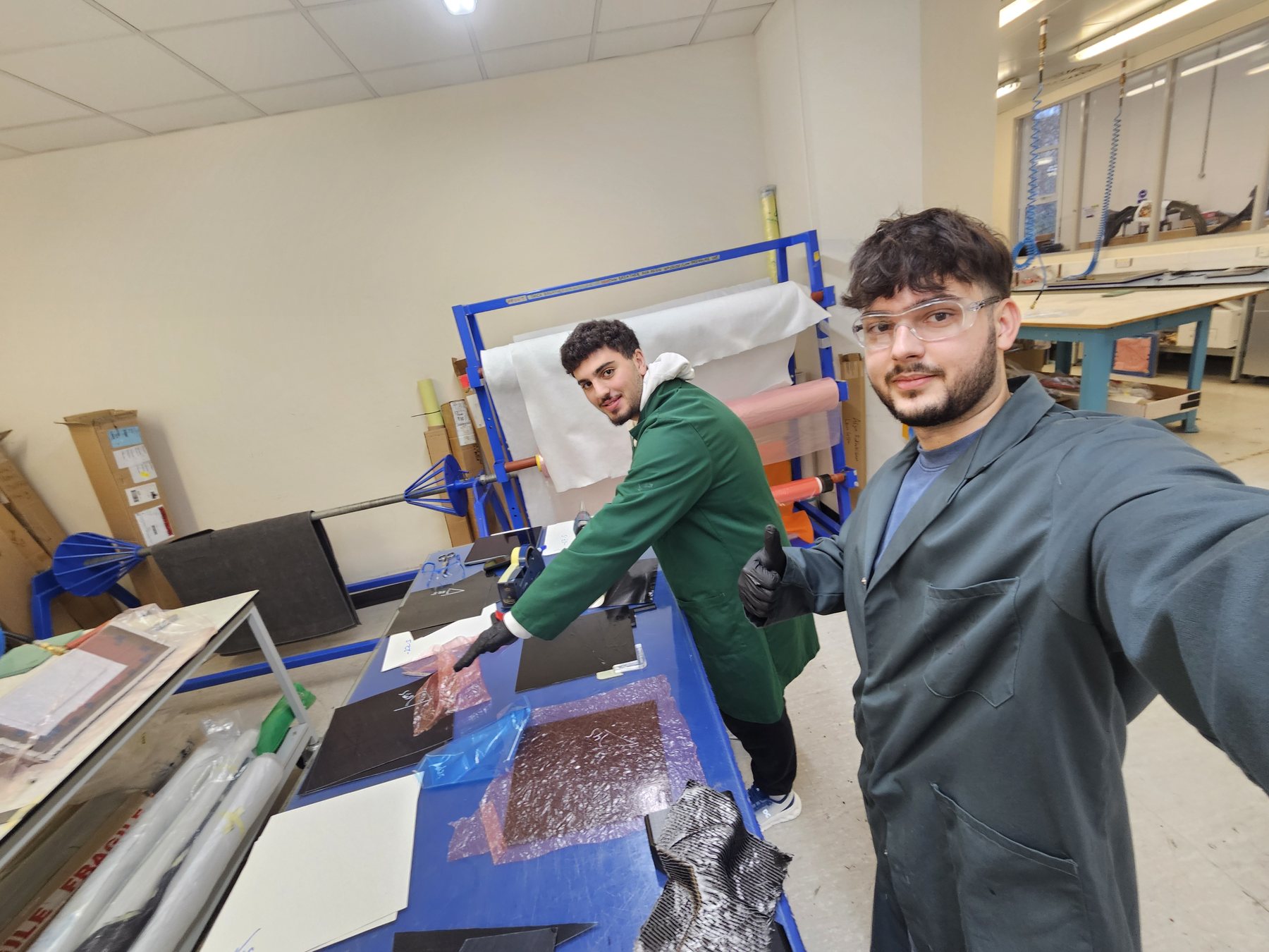Juan and a colleague working with carbon fabric in the composites laboratory